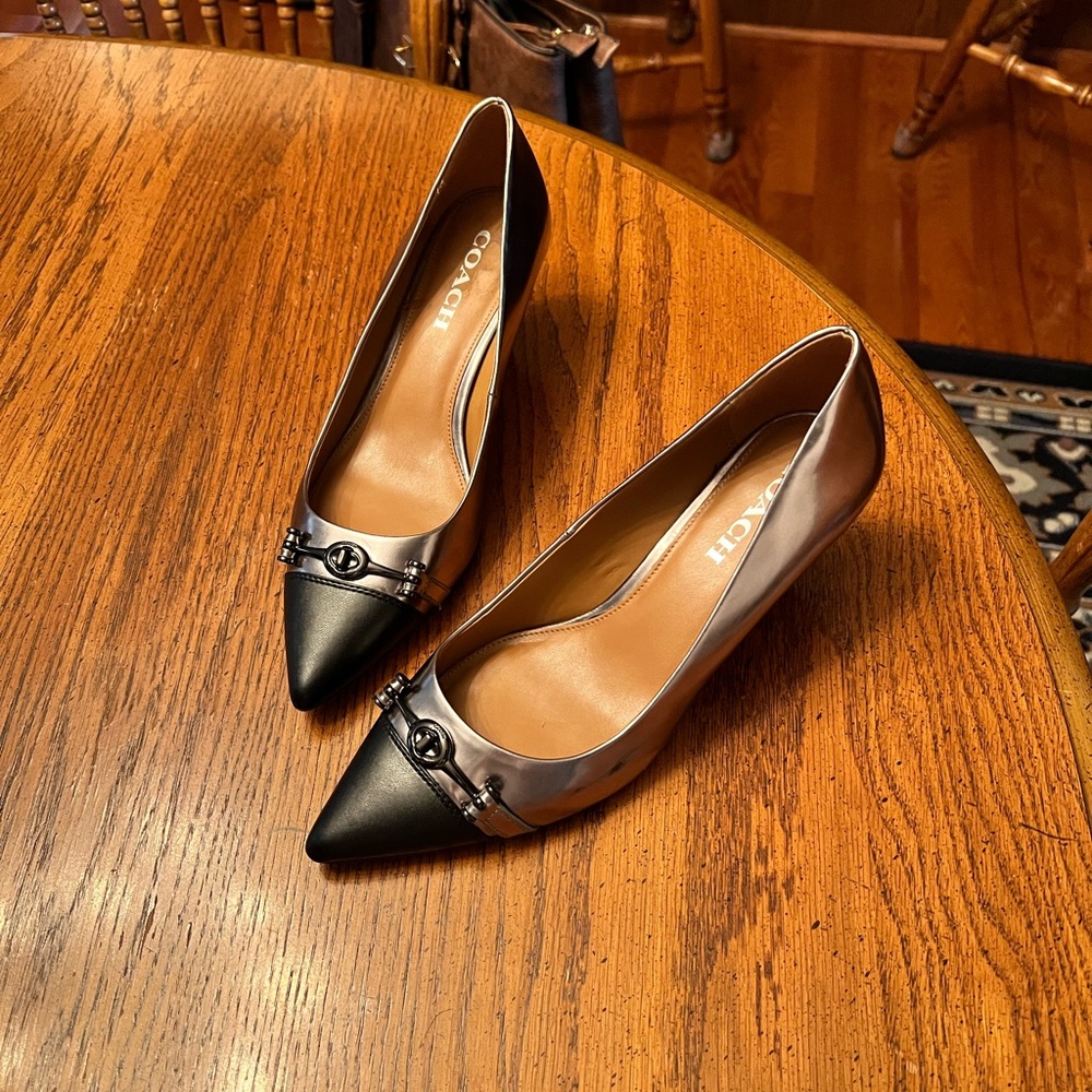 Coach pumps in metallic silver with black toe tips. Size 9.